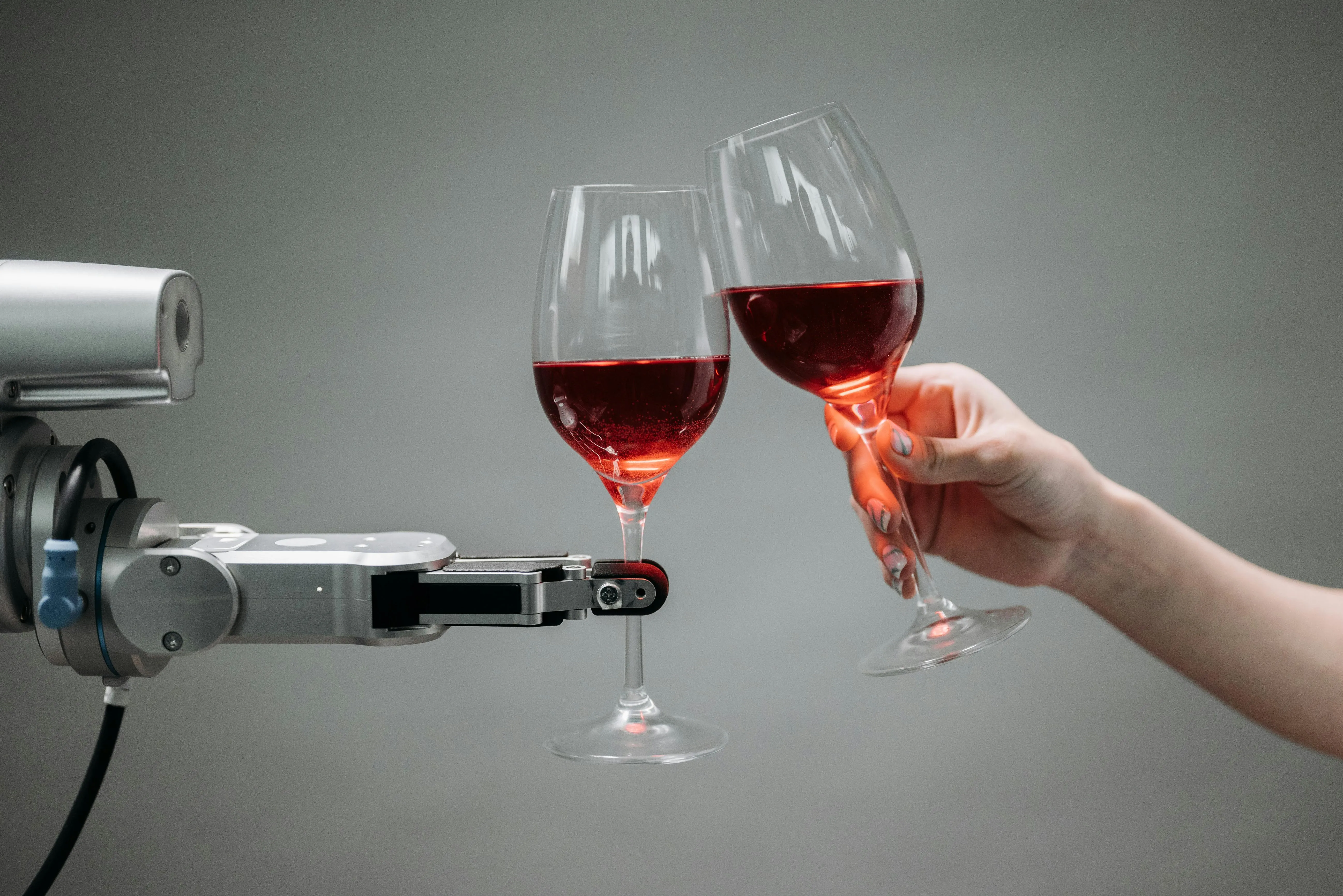 Robô serve taças de vinho tinto em experimento de tecnologia e inteligência artificial.